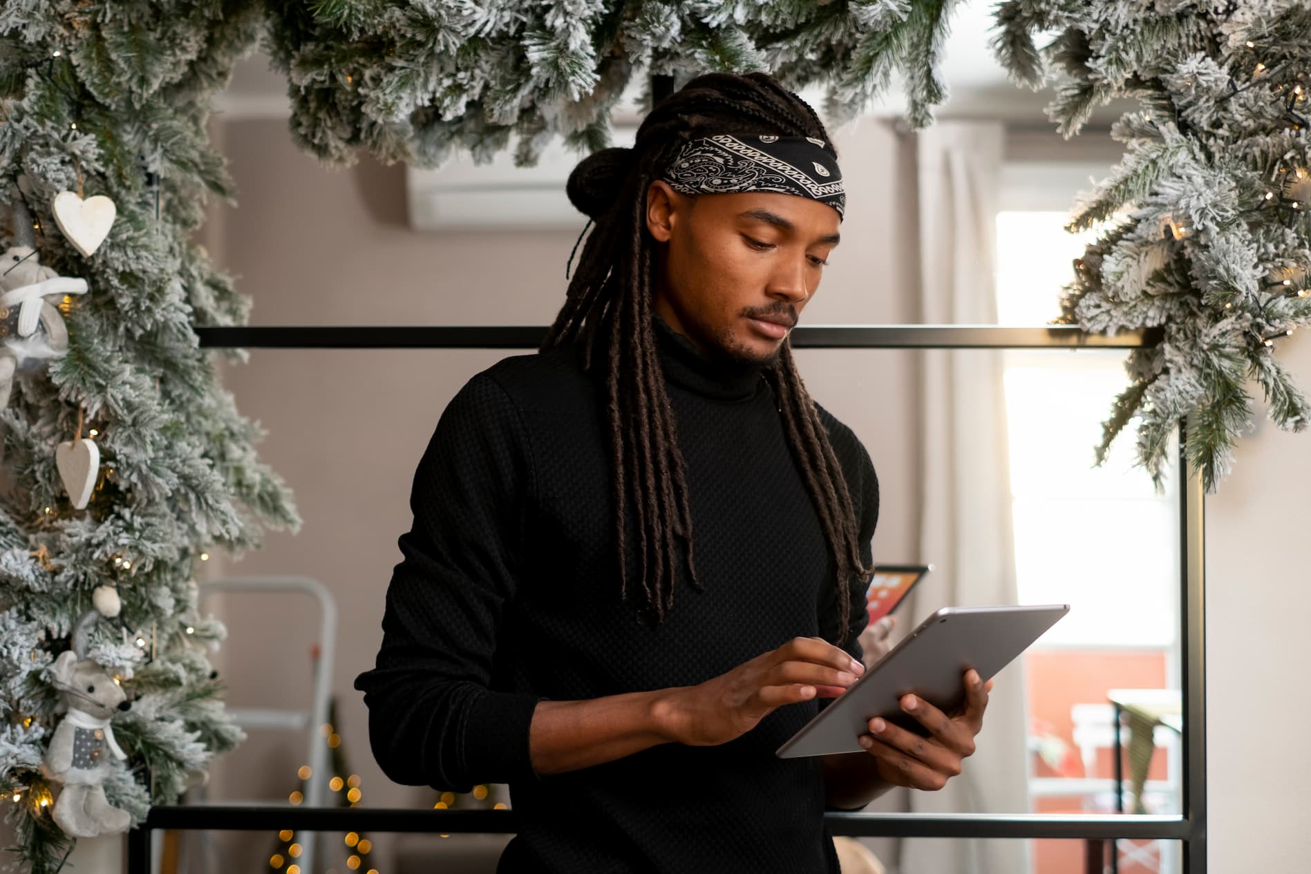 A beauty business owner man holding tablet - how to manage your salon